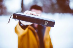 man holding Bible