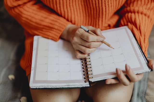 Female checking personal planner. Our plans or God's plans?