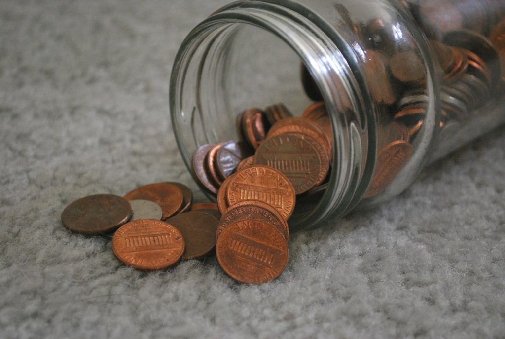 jar of pennies showing poverty, an essential in kingdom success
